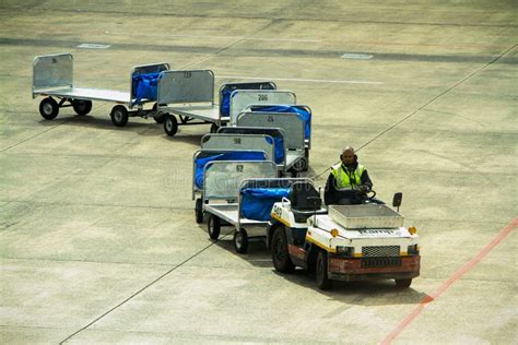 a baggage carrier at an airport figgerits|A baggage carrier at an airport Figgerits .